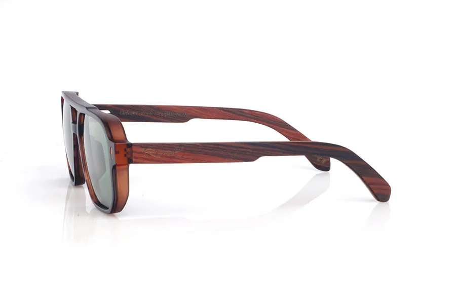 Wood eyewear of Rosewood CLAY. The wooden sunglasses CLAY combine a navigator-inspired design with bold lines and a tortoiseshell-finish front, delivering a warm look full of personality. Their rosewood temples stand out for their pronounced grain and deep tone, giving the whole frame an elegant, handcrafted character. The structure feels solid yet comfortable, thanks to the lightweight design and the curve of the temples, which helps maintain a stable fit for everyday wear. A modern, timeless model designed for daily use, with full UV protection.

Dimensions: 147x48 mm
Caliber: 54
 for Wholesale & Retail | Root Sunglasses® 
