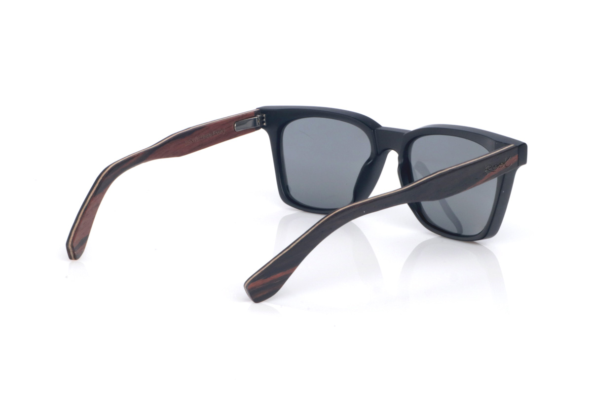 Wood eyewear of Ebony DENVER. The wooden sunglasses DENVER combine a bold, square silhouette with a matte black front, creating a clean and highly versatile look. Their ebony temples add an elegant handcrafted touch, with a subtle grain and a natural finish that contrasts with the solid front. The frame offers comfortable everyday wear thanks to its lightweight build and the curve of the temples, which helps keep a stable fit. A modern, timeless model designed for daily use, with full UV protection.

Dimensions: 145x47 mm
Caliber: 52 for Wholesale & Retail | Root Sunglasses® 