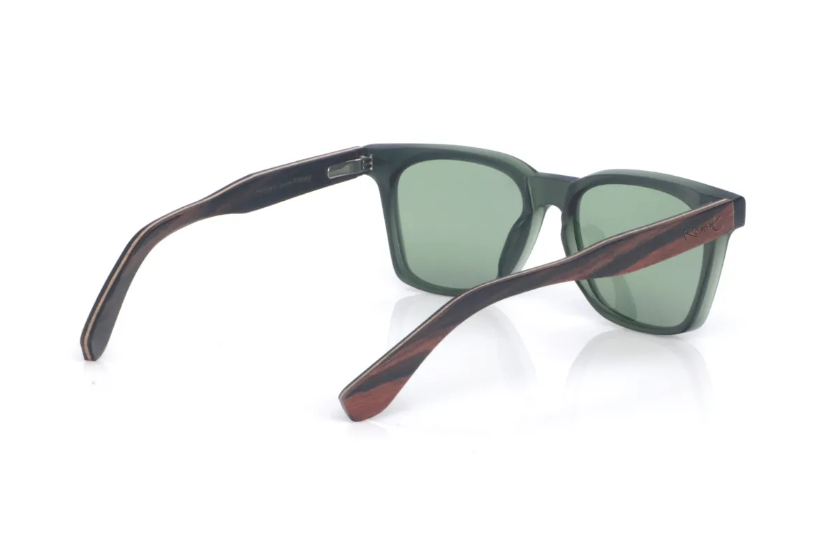 Wood eyewear of Ebony ROWAN. The ROWAN wooden sunglasses combine a modern, square silhouette with a dark translucent green front, creating a clean, contemporary look that’s easy to wear. Their ebony temples add an elegant handcrafted touch, with a subtle grain and a natural finish that balances the overall design. The frame offers a comfortable everyday fit thanks to its lightweight feel and the curvature of the temples, which helps keep a stable hold. A versatile, timeless model designed to go with you every day, with full protection against UV rays.

Dimensions: 145x47 mm
Lens width: 52
 for Wholesale & Retail | Root Sunglasses® 