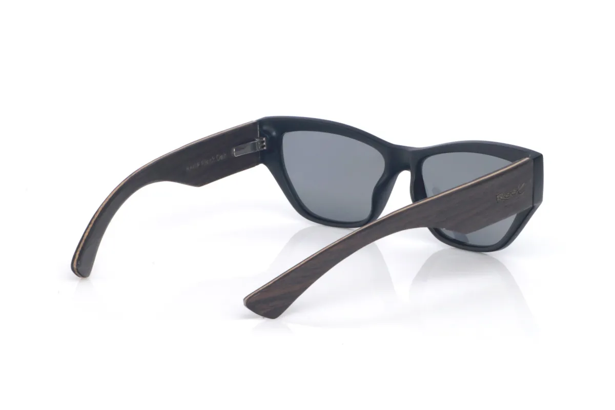 Wood eyewear of Oak SAGE B. The SAGE B OAK wooden sunglasses feature a soft cat-eye design, with a subtle upward line at the corners that flatters the look without feeling exaggerated. The black front adds an elegant touch that’s easy to match with anything, while the contrast with the oak temples brings a warm, natural feel that makes them stand out.

One of their nicest features is the wide temples: beyond reinforcing the character of the model, they visually balance the frame and give the impression of a solid, well-crafted piece. The curve of the temples helps them sit securely, and the overall build stays comfortable for everyday wear, with full UV protection.

Dimensions: 14x45 mm
Lens width (caliber): 55

 for Wholesale & Retail | Root Sunglasses® 