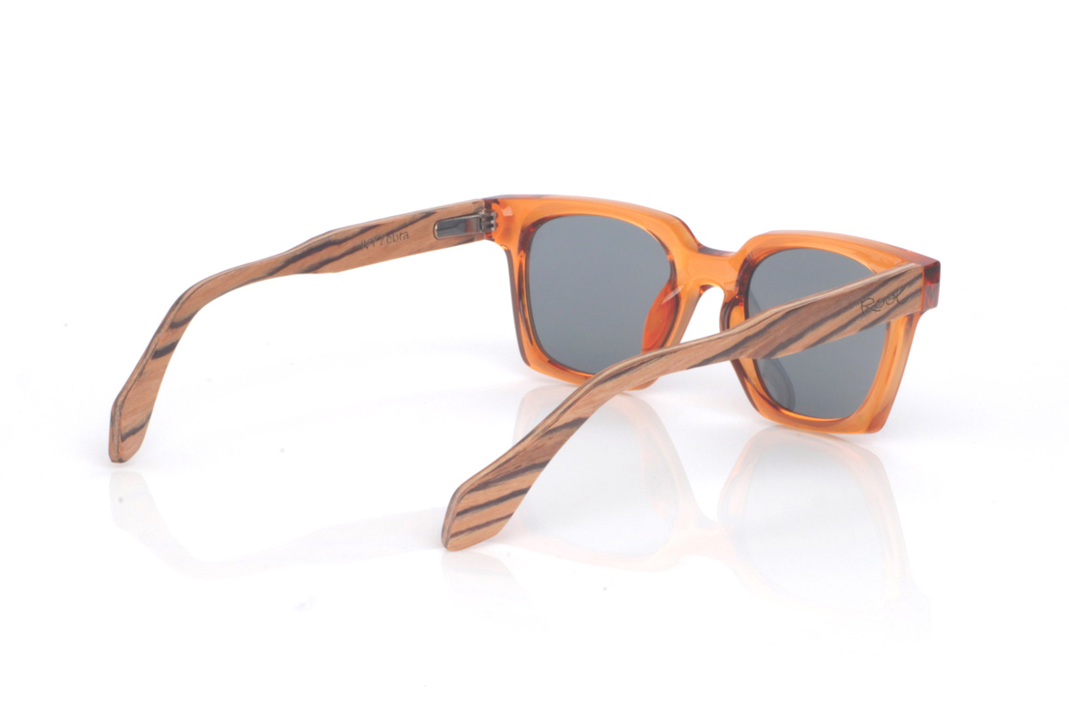 Wood eyewear of Zebrano IVY. The IVY wooden sunglasses combine a translucent amber/orange front, bright and eye-catching, with a softly contoured rectangular shape that feels balanced and flattering. The glossy finish enhances the colour and gives it a modern feel, perfect for summer looks.

Zebrano wood temples add a natural contrast with their distinctive striped grain, making each pair slightly unique. A bold, comfortable and versatile model for everyday wear, with full UV protection.

Dimensions: 140x46 mm
Lens width: 47
 for Wholesale & Retail | Root Sunglasses® 