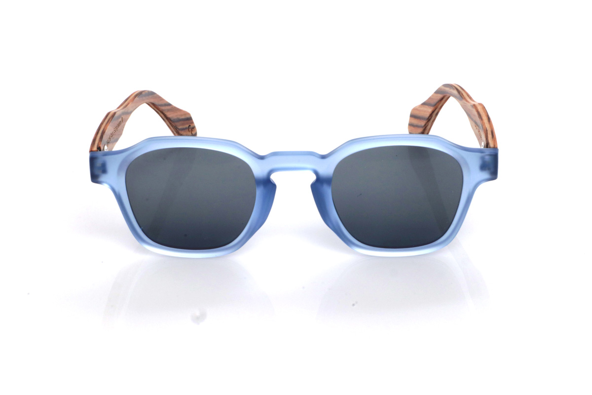 Wood eyewear of Zebrano LILY. The LILY wooden sunglasses combine a translucent light-blue front, fresh and very on-trend, with a rounded-oval shape and soft lines that feels comfortable and easy to wear. The satin/translucent finish adds a light, luminous touch, ideal for a relaxed style with personality.

Zebrano wood temples add contrast and warmth thanks to their distinctive striped grain, creating a very original mix of colour and natural wood. A versatile model for everyday wear, with full UV protection.

Dimensions: 144x46 mm
Lens width: 46
 for Wholesale & Retail | Root Sunglasses® 