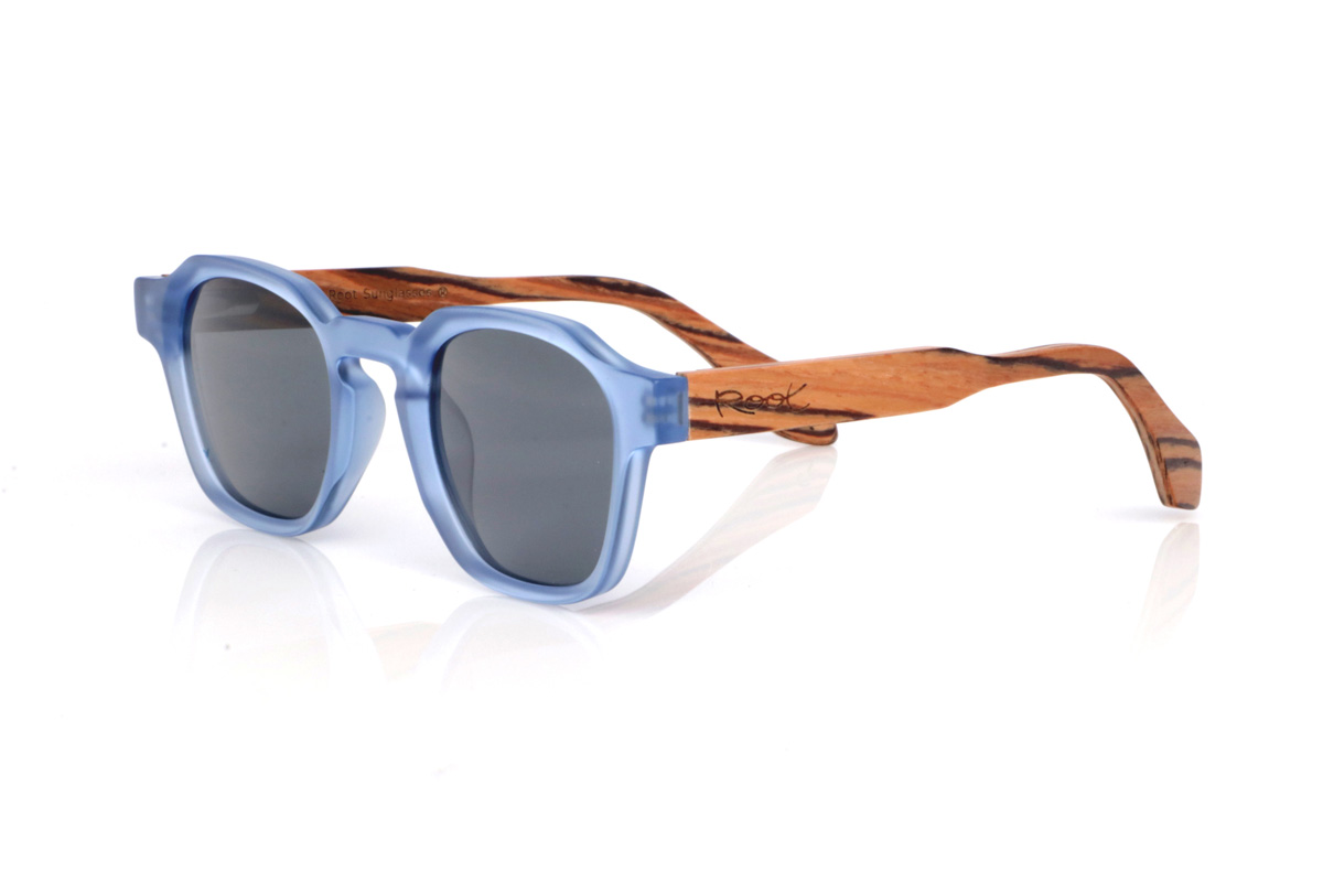 Wood eyewear of Zebrano LILY. The LILY wooden sunglasses combine a translucent light-blue front, fresh and very on-trend, with a rounded-oval shape and soft lines that feels comfortable and easy to wear. The satin/translucent finish adds a light, luminous touch, ideal for a relaxed style with personality.

Zebrano wood temples add contrast and warmth thanks to their distinctive striped grain, creating a very original mix of colour and natural wood. A versatile model for everyday wear, with full UV protection.

Dimensions: 144x46 mm
Lens width: 46
 for Wholesale & Retail | Root Sunglasses® 