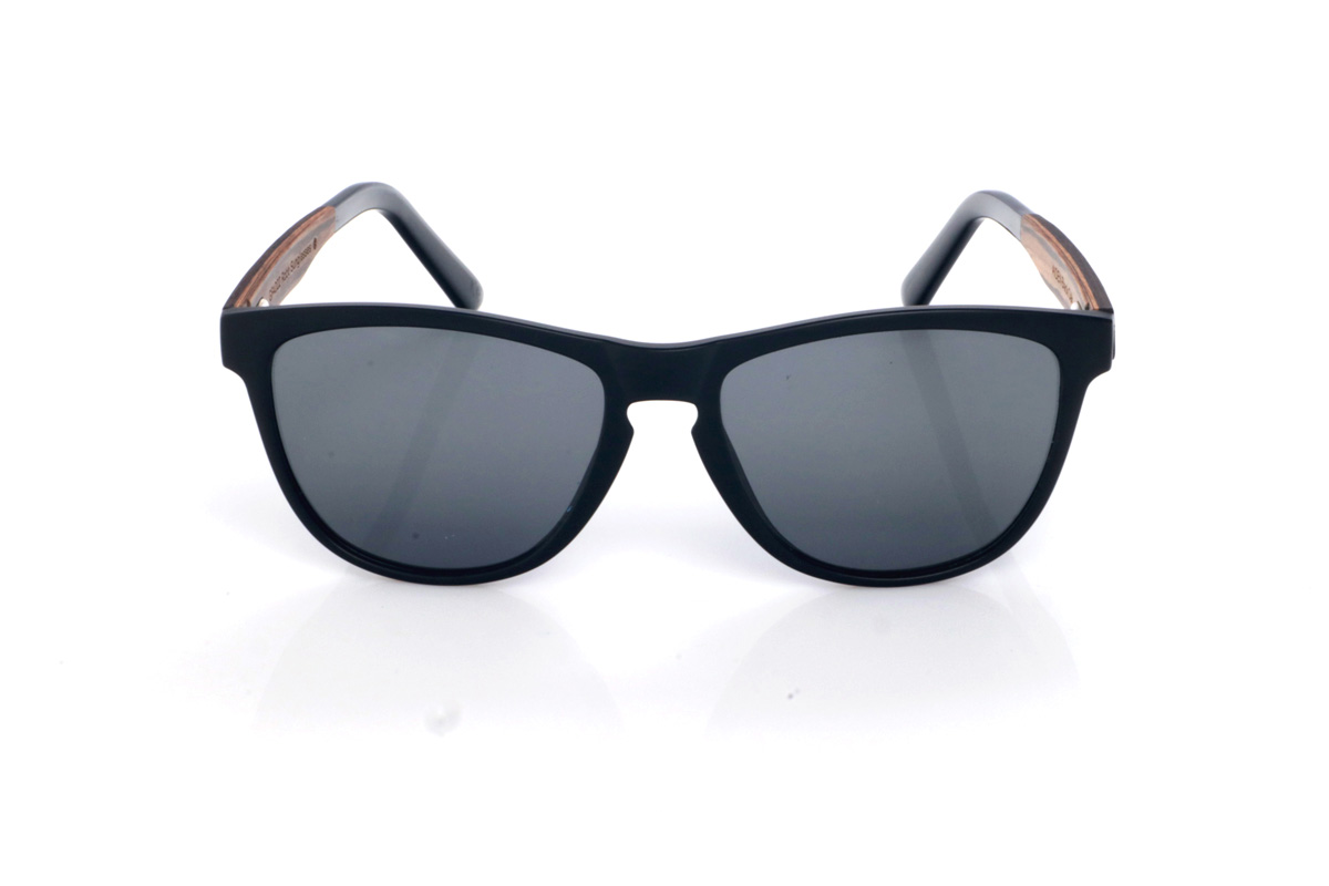 Wood eyewear of Oak AIDEN. The AIDEN wooden sunglasses combine a soft-finish black front with a slightly wraparound silhouette that balances presence and comfort. The design features clean lines and a streamlined outline, with a shape between rectangular and oval that feels flattering and easy to wear every day. The bridge with a subtle opening adds a classic, functional touch while keeping the overall look modern and understated.

Black oak temples add the natural contrast of dark wood, with a discreet grain that gives each pair its own unique nuances. A versatile, comfortable and stable model, made to accompany you daily with full UV protection.

Dimensions: 141x49 mm
Lens width: 54
 for Wholesale & Retail | Root Sunglasses® 