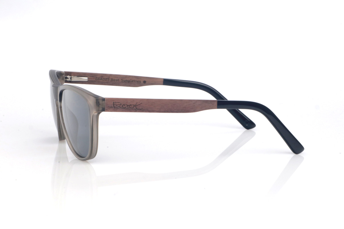 Wood eyewear of Walnut DECLAN. The DECLAN wooden sunglasses combine a translucent smoke/sand front, light and elegant, with a softly wraparound silhouette that feels comfortable and flattering. The design keeps clean lines and a streamlined outline, with a shape between rectangular and oval that suits many face shapes. The bridge with a subtle opening adds a classic touch while maintaining a modern, easy-to-wear style.

Walnut wood temples bring warmth and a natural finish with subtle grain, giving each pair its own character. A versatile model for everyday wear, with full UV protection.

Dimensions: 141x49 mm
Lens width: 54
 for Wholesale & Retail | Root Sunglasses® 