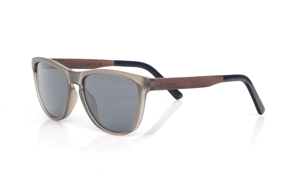Wood eyewear of Walnut DECLAN. The DECLAN wooden sunglasses combine a translucent smoke/sand front, light and elegant, with a softly wraparound silhouette that feels comfortable and flattering. The design keeps clean lines and a streamlined outline, with a shape between rectangular and oval that suits many face shapes. The bridge with a subtle opening adds a classic touch while maintaining a modern, easy-to-wear style.

Walnut wood temples bring warmth and a natural finish with subtle grain, giving each pair its own character. A versatile model for everyday wear, with full UV protection.

Dimensions: 141x49 mm
Lens width: 54
 for Wholesale & Retail | Root Sunglasses® 