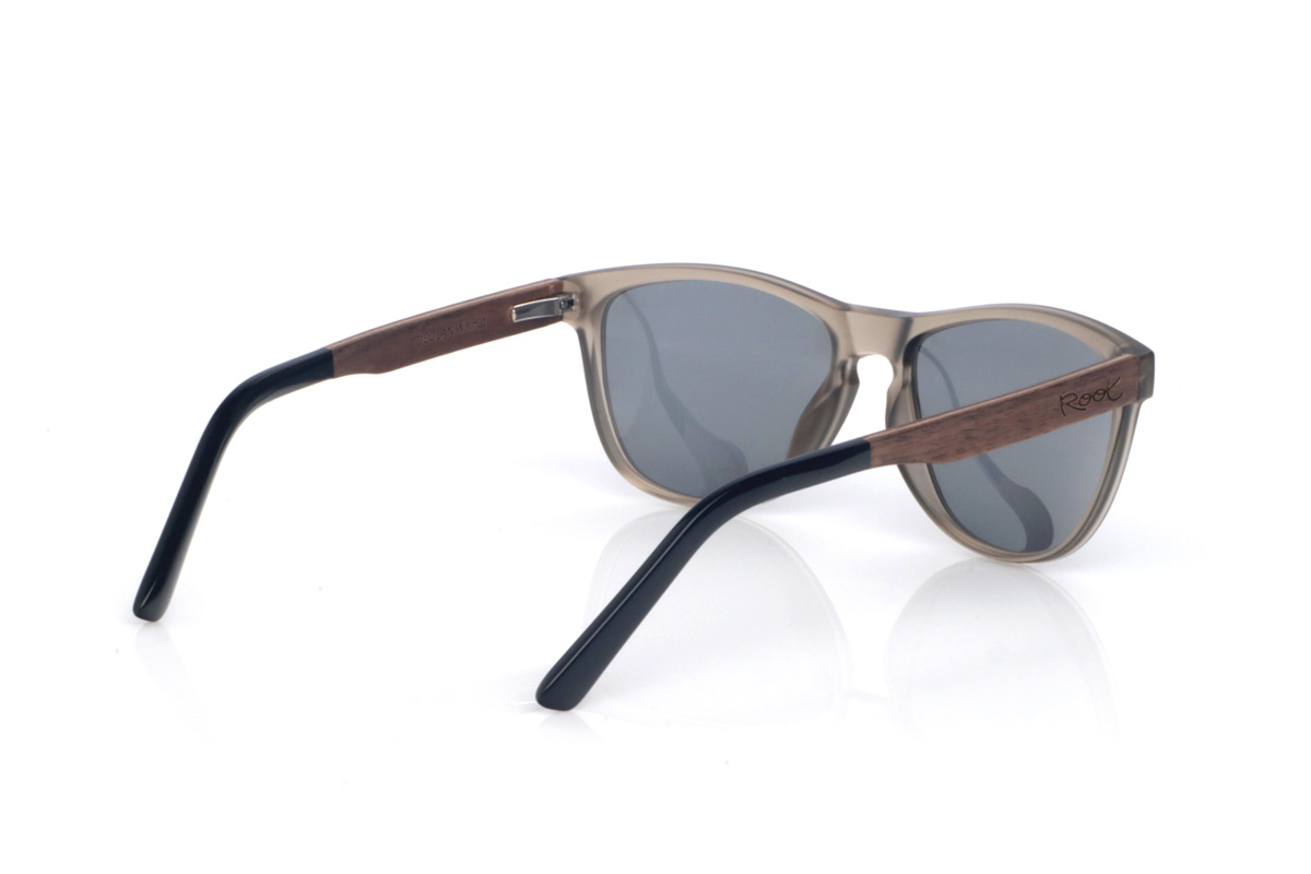 Wood eyewear of Walnut DECLAN. The DECLAN wooden sunglasses combine a translucent smoke/sand front, light and elegant, with a softly wraparound silhouette that feels comfortable and flattering. The design keeps clean lines and a streamlined outline, with a shape between rectangular and oval that suits many face shapes. The bridge with a subtle opening adds a classic touch while maintaining a modern, easy-to-wear style.

Walnut wood temples bring warmth and a natural finish with subtle grain, giving each pair its own character. A versatile model for everyday wear, with full UV protection.

Dimensions: 141x49 mm
Lens width: 54
 for Wholesale & Retail | Root Sunglasses® 