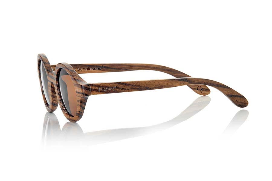 Wood eyewear of Zebrano BOHO ECO. The Boho Eco sun glasses are made of Zebrano wood combined with gray or brown lenses. It is a round pattern with peaks at the sides and metal ornaments at the ends made with a beautiful wood that adds an elegant at  bohemian look to your point of view. Measurements: 147x48mm for Wholesale & Retail | Root Sunglasses® 