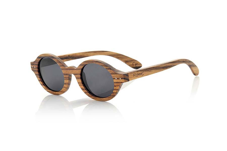 Wood eyewear of Zebrano BOHO ECO. The Boho Eco sun glasses are made of Zebrano wood combined with gray or brown lenses. It is a round pattern with peaks at the sides and metal ornaments at the ends made with a beautiful wood that adds an elegant at  bohemian look to your point of view. Measurements: 147x48mm for Wholesale & Retail | Root Sunglasses® 