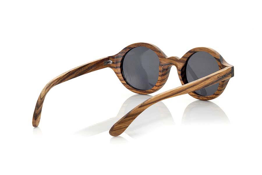 Wood eyewear of Zebrano BOHO ECO. The Boho Eco sun glasses are made of Zebrano wood combined with gray or brown lenses. It is a round pattern with peaks at the sides and metal ornaments at the ends made with a beautiful wood that adds an elegant at  bohemian look to your point of view. Measurements: 147x48mm for Wholesale & Retail | Root Sunglasses® 