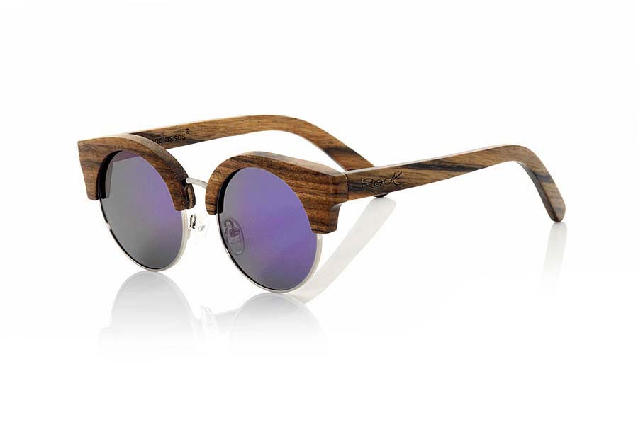 Wood eyewear of Ebony KALAHARI. Kalahari sunglasses are perform in ebony combined with purple lenses REVO, it is a spectacular model made in hardwood with boho look and a standard size. KALAHARI sunglasses include a practical folding case that keeps your glasses safe when they are  inside and takes up very little space when folded.Front size: 142x55mm for Wholesale & Retail | Root Sunglasses® 