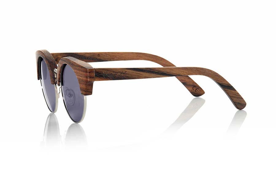 Wood eyewear of Ebony KALAHARI. Kalahari sunglasses are perform in ebony combined with purple lenses REVO, it is a spectacular model made in hardwood with boho look and a standard size. KALAHARI sunglasses include a practical folding case that keeps your glasses safe when they are  inside and takes up very little space when folded.Front size: 142x55mm for Wholesale & Retail | Root Sunglasses® 