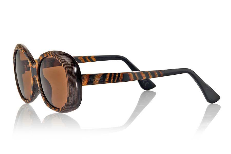 Wood eyewear of Maple KARA. Kara sunglasses are a unique model made by hand with 25 thin layers of natural maple wood stained in brown and golden brown colors combined with brown lenses. Both the saddle and the pins 25 comprise thin layers stained maple wood and pressed to be ground with the shape of the frame form a pattern of special colors. The legs are finished in acetate and the whole was decorated with a soft varnish which gives brightness. The Kara will surprise you with its beauty painstaking manual labor and perfect finish. KARA sunglasses include a practical folding case that keeps your glasses safe when they are  inside and takes up very little space when folded.Front Measure: 149x56mm for Wholesale & Retail | Root Sunglasses® 