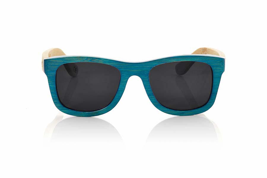 Wood eyewear of Bamboo TROPICBLUE. TropicBlue sunglasses are made of bamboo wood with the front in blue and sideburns in natural bamboo combined with blue mirror lenses. It is a classic frame that adapts well to all kinds of faces for them and for them with which you will not go unnoticed.  Front measssure: 147x50mm for Wholesale & Retail | Root Sunglasses® 