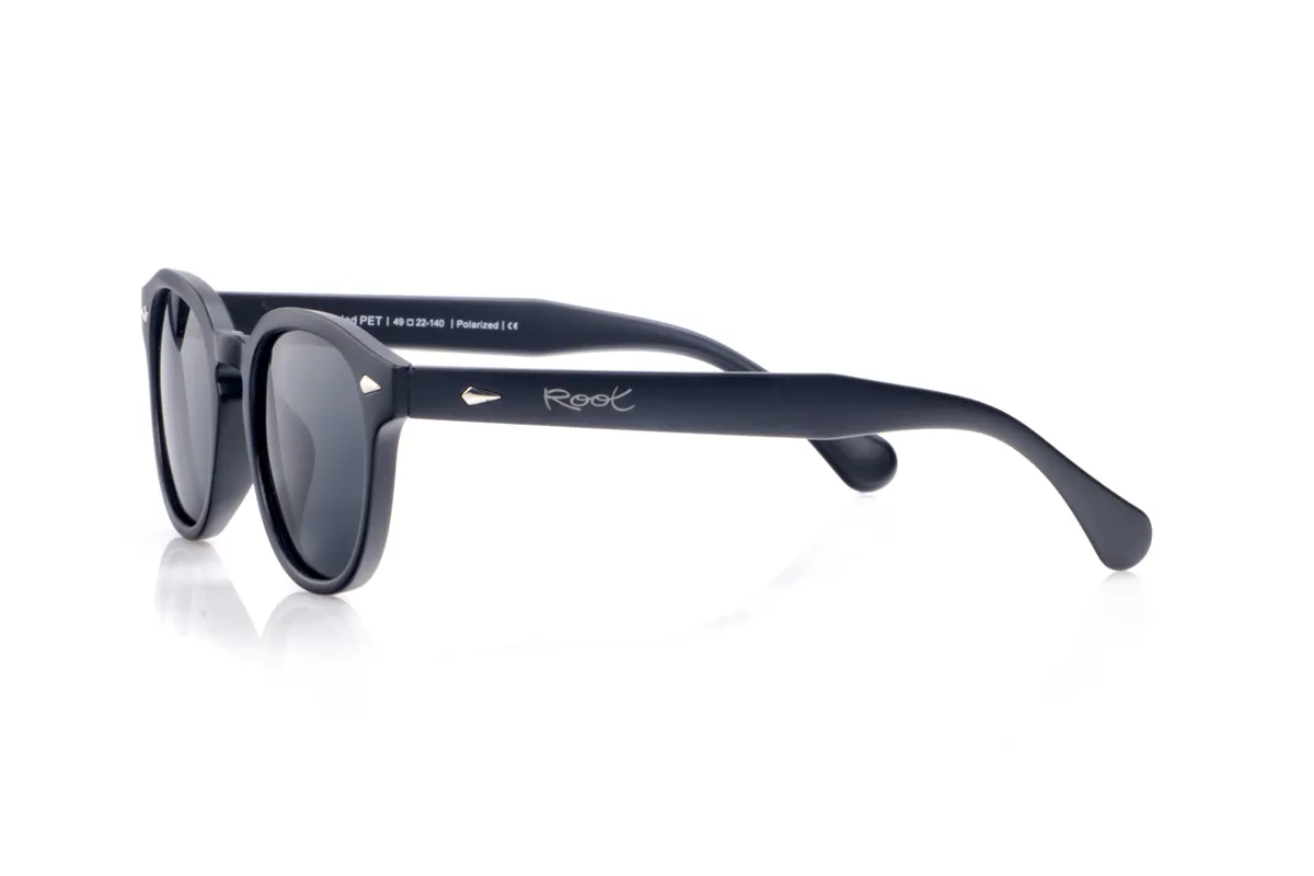 Wood eyewear of Pet DIANT. DIANT sunglasses are crafted from recycled PET plastic, transforming bottles into a lightweight, durable frame with a timeless style. Their gently square shape with rounded edges and a sculpted bridge flatters a variety of face shapes, making them a perfect unisex everyday essential. The uniform finish enhances the frame's clean lines and highlights the small metal accents on the front and temples, adding a modern touch without overwhelming the design. The wide, gently curved temples fit comfortably and provide a stable feel even during extended wear. Equipped with high-quality polarized lenses, DIANT sunglasses reduce glare and protect your eyes from UV rays, making them ideal recycled sunglasses for those seeking functionality, understated elegance, and a commitment to the planet all in one. Dimensions: 143 x 48 mm; Lens width: 48 mm for Wholesale & Retail | Root Sunglasses® 