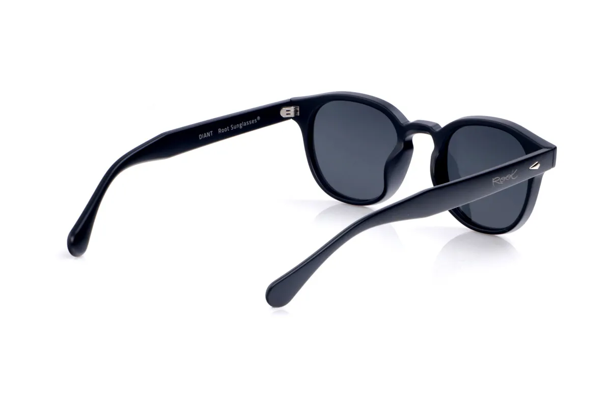 Wood eyewear of Pet DIANT. DIANT sunglasses are crafted from recycled PET plastic, transforming bottles into a lightweight, durable frame with a timeless style. Their gently square shape with rounded edges and a sculpted bridge flatters a variety of face shapes, making them a perfect unisex everyday essential. The uniform finish enhances the frame's clean lines and highlights the small metal accents on the front and temples, adding a modern touch without overwhelming the design. The wide, gently curved temples fit comfortably and provide a stable feel even during extended wear. Equipped with high-quality polarized lenses, DIANT sunglasses reduce glare and protect your eyes from UV rays, making them ideal recycled sunglasses for those seeking functionality, understated elegance, and a commitment to the planet all in one. Dimensions: 143 x 48 mm; Lens width: 48 mm for Wholesale & Retail | Root Sunglasses® 