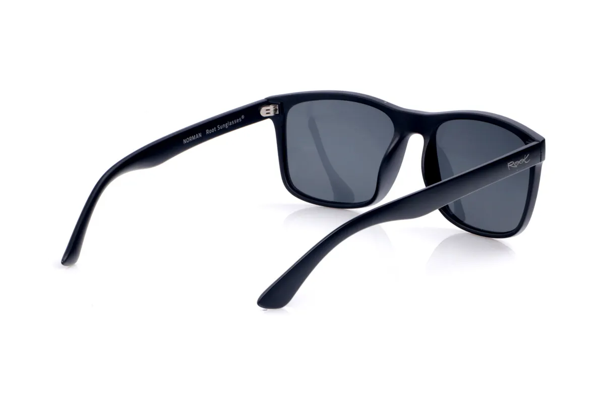 Wood eyewear of Pet NORMAN. NORMAN sunglasses are made from recycled PET plastic, transforming bottles into a lightweight, durable, and eco-conscious frame. Their slightly curved rectangular shape is reminiscent of classic models, with clean lines that lend an urban style that's easy to coordinate. The matte finish front and slim temples create a sophisticated and modern look, while the gentle curve of the temples ensures a comfortable and stable fit all day long. Equipped with high-quality polarized lenses, NORMAN sunglasses effectively reduce glare and protect your eyes from UV rays, making them the perfect recycled sunglasses for those seeking a versatile, functional, and timeless design for everyday wear. Dimensions: 144 x 50 mm; Lens width: 54 for Wholesale & Retail | Root Sunglasses® 