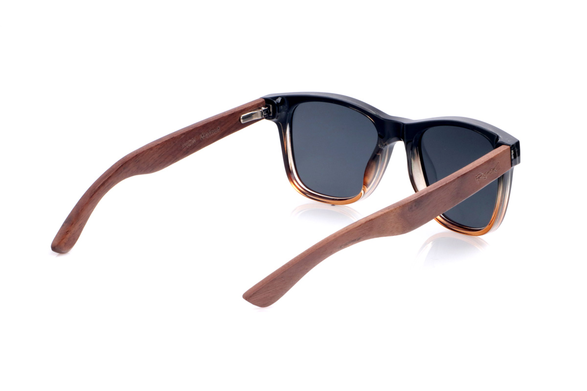 Wood eyewear of Walnut DION. The <b>DION</b> sunglasses combine a black acetate front with an amber gradient at the bottom and walnut wood temples, creating a warm and contemporary contrast. Their classic wayfarer-inspired shape flatters most faces, while the small metal accents on the front add an urban and elegant touch. The natural grain of the walnut makes each pair unique, and thanks to their lightness and gently curved temples, they are comfortable to wear all day. They feature polarized gradient lenses that reduce glare and provide effective UV protection. Measurements: 145 x 49 mm. Lens width: 51 mm. for Wholesale & Retail | Root Sunglasses® 