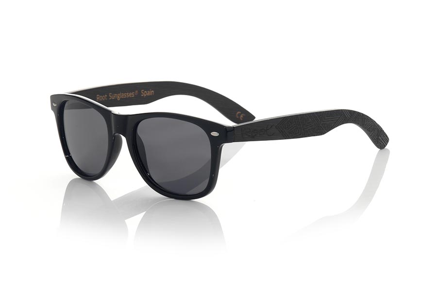 Wood eyewear of Bamboo SKA BLACK. The Ska black sunglasses are made with the black glossy PC front and the black tinted natural bamboo wood sideburns engraved with an ethnic pattern, combined with various colors of lenses that suit your style. Frontal measurement: 148x50mm for Wholesale & Retail | Root Sunglasses® 