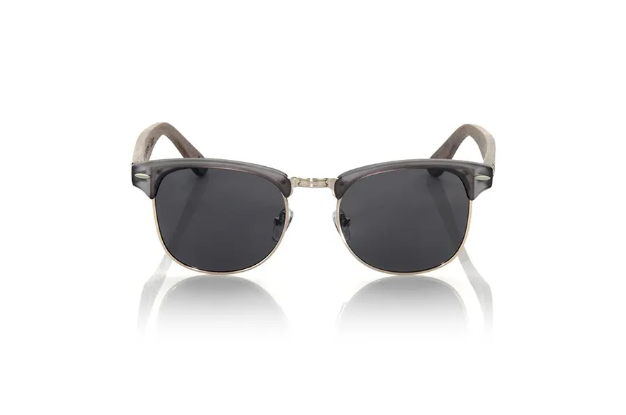 Wood eyewear of Walnut TINE. The TINE sunglasses are made with the PC front in Matt Transparent grey and gold metal and the sideburns in natural walnut vintage effect, combined with various colors of lenses adapt to your style. Front measurement: 148x50mm * Note the vintage effect is a stripping technique whose result varies from one model to another so the pattern can vary from one model to another, and may not exactly match the displayed images what makes each of the goggles unique. for Wholesale & Retail | Root Sunglasses® 