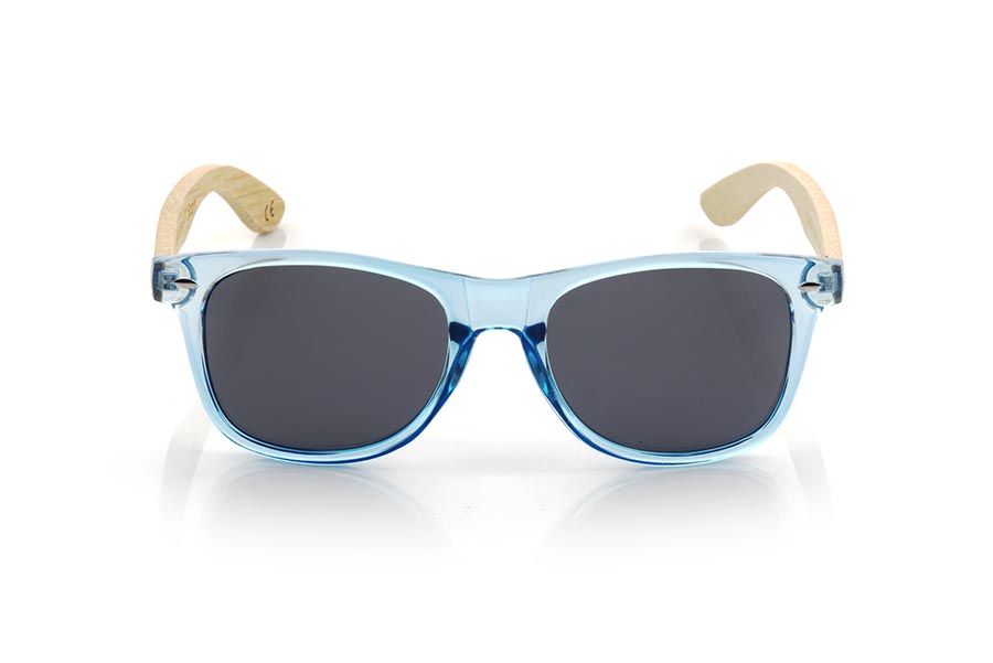 Wood eyewear of Bamboo CANDY BLUE DS. The Candy BLUE DS sunglasses are made with the front in transparent glossy clear Blue synthetic material and natural bamboo wood sideburns combined with four colors of lenses that will allow you to adapt them to your style. Frontal measurement: 148x50mm for Wholesale & Retail | Root Sunglasses® 