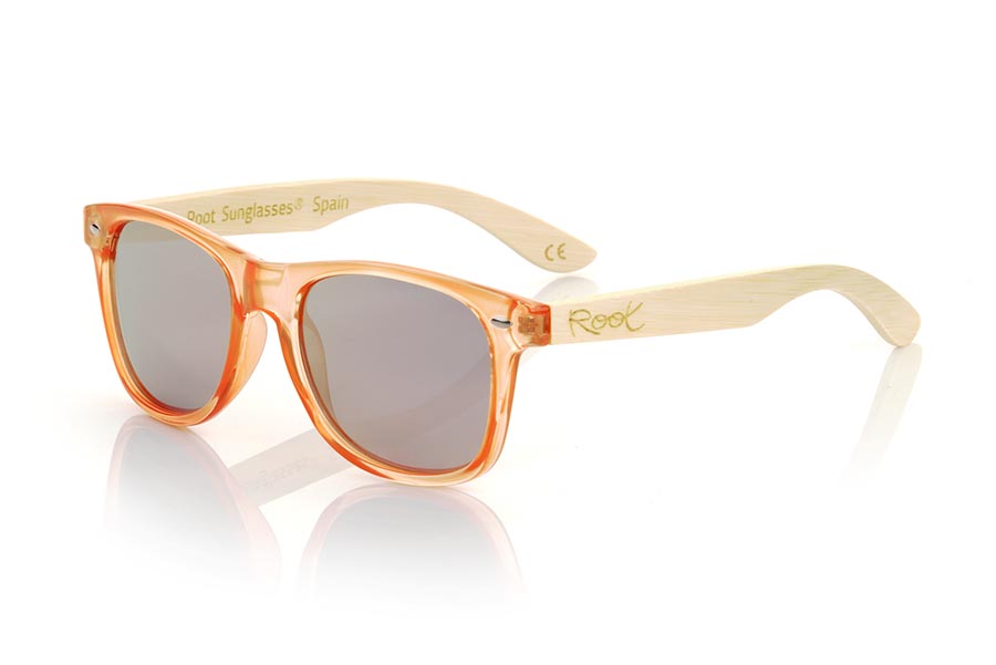 Wood eyewear of Bamboo CANDY ORANGE DS. The Candy ORANGE DS sunglasses are made with the front in transparent glossy clear Orange synthetic material and natural bamboo wood sideburns combined with four colors of lenses that will allow you to adapt them to your style. Frontal measurement: 148x50mm for Wholesale & Retail | Root Sunglasses® 