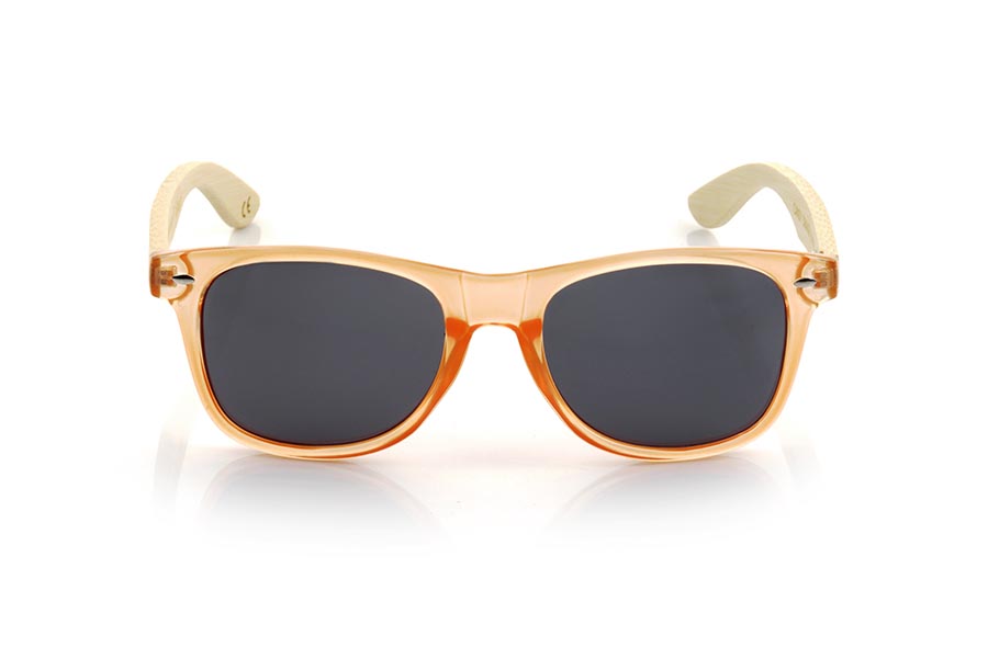 Wood eyewear of Bamboo CANDY ORANGE DS. The Candy ORANGE DS sunglasses are made with the front in transparent glossy clear Orange synthetic material and natural bamboo wood sideburns combined with four colors of lenses that will allow you to adapt them to your style. Frontal measurement: 148x50mm for Wholesale & Retail | Root Sunglasses® 