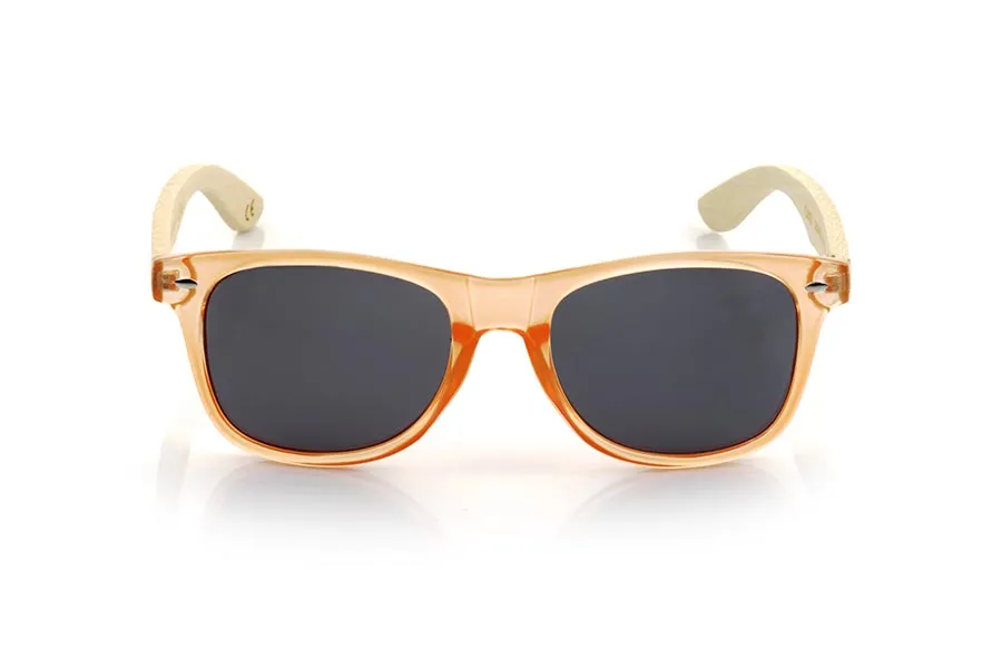 Wood eyewear of Bamboo CANDY ORANGE DS. The Candy ORANGE DS sunglasses are made with the front in transparent glossy clear Orange synthetic material and natural bamboo wood sideburns combined with four colors of lenses that will allow you to adapt them to your style. Frontal measurement: 148x50mm for Wholesale & Retail | Root Sunglasses® 