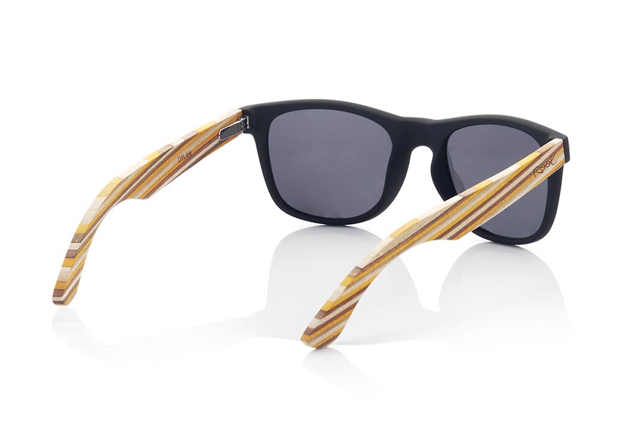 Wood eyewear of Maple DYLAN. DYLAN sunglasses are made with a matte black PC front, laminated MAPLE wood temples, natural Skateboard effect, laminated multicolored, combined with various colors of lenses that adapt to your style. Front measurement: 148x50mm *note the layout of the laminate colors may vary from one goggle to another. for Wholesale & Retail | Root Sunglasses® 