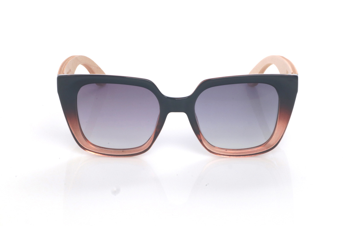 Wood eyewear of Maple SUMAYA. The SUMAYA wooden sunglasses stand out with an oversized, squared silhouette with a subtle cat-eye touch that’s flattering and full of presence. The finish blends a soft black on the upper part with a translucent gradient in rosy/amber tones at the base, creating a stylish, modern contrast.

Maple wood temples add visual lightness and a natural touch that balances the design, with a clean, comfortable profile for everyday wear. A perfect choice if you’re looking for a bold, feminine look that’s easy to match.

Dimensions: 145x42
Calibre: 50
 for Wholesale & Retail | Root Sunglasses® 