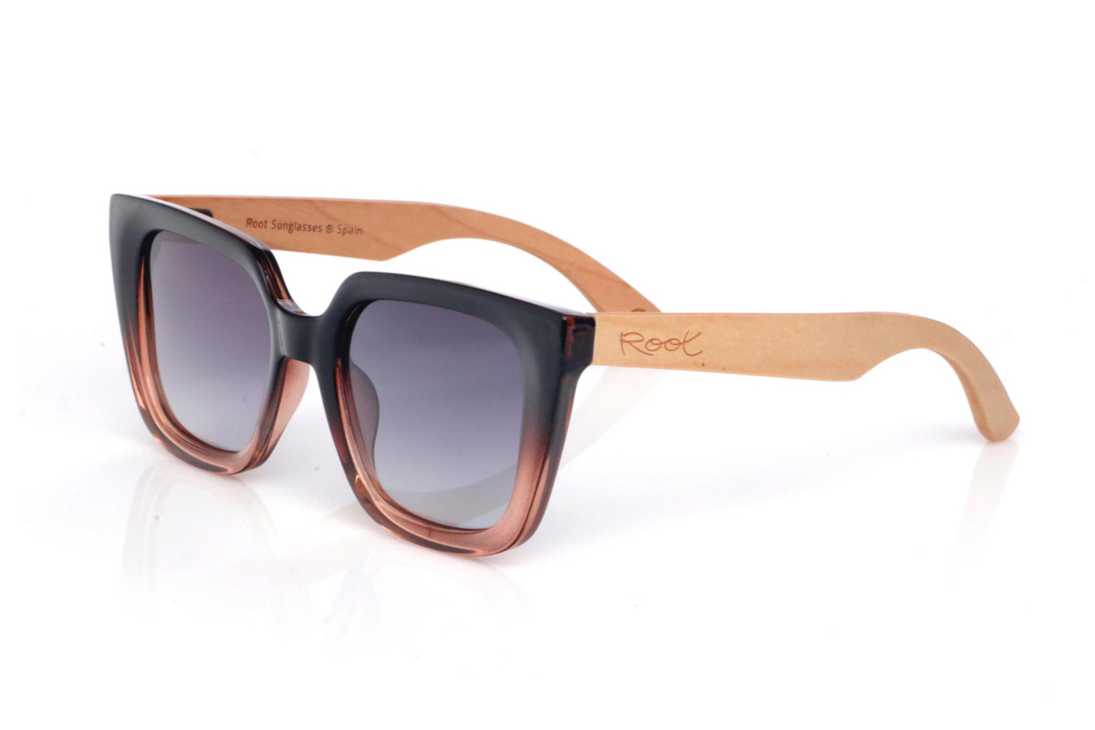 Wood eyewear of Maple SUMAYA. The SUMAYA wooden sunglasses stand out with an oversized, squared silhouette with a subtle cat-eye touch that’s flattering and full of presence. The finish blends a soft black on the upper part with a translucent gradient in rosy/amber tones at the base, creating a stylish, modern contrast.

Maple wood temples add visual lightness and a natural touch that balances the design, with a clean, comfortable profile for everyday wear. A perfect choice if you’re looking for a bold, feminine look that’s easy to match.

Dimensions: 145x42
Calibre: 50
 for Wholesale & Retail | Root Sunglasses® 
