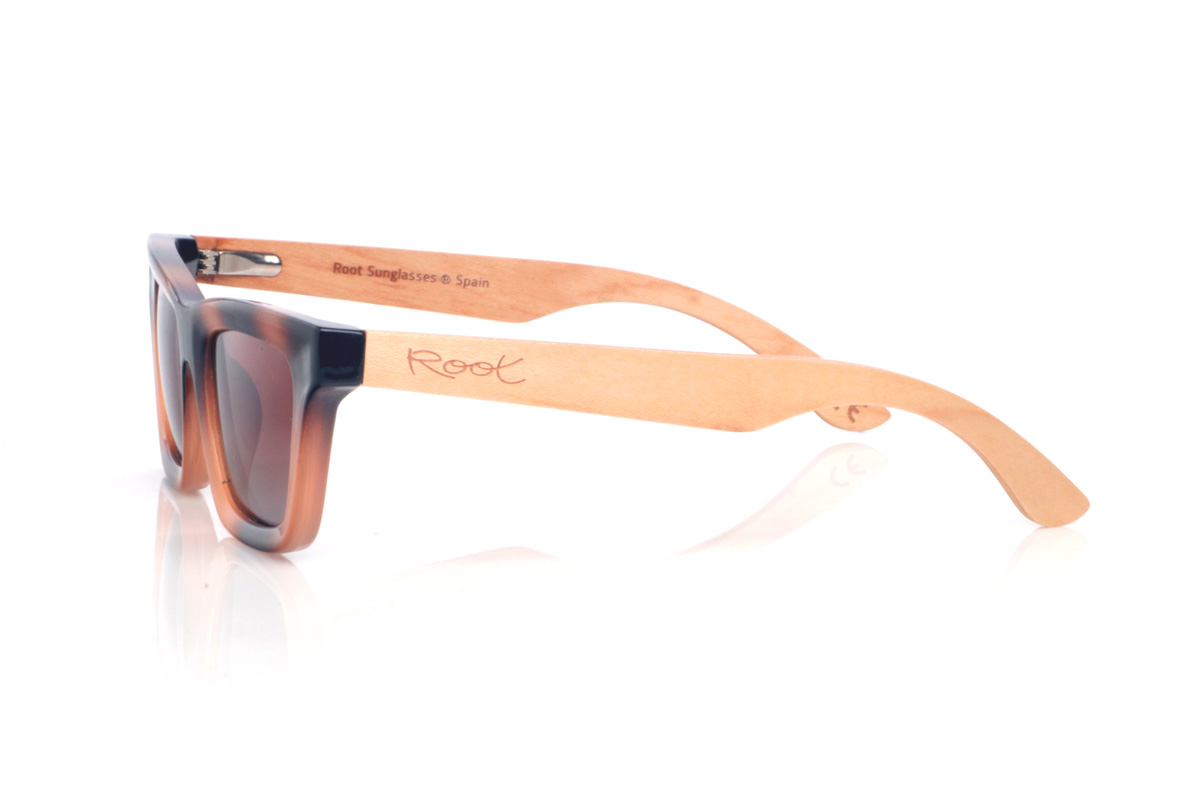 Wood eyewear of Maple MIRANDA. The MIRANDA wooden sunglasses combine clean, straight lines with a subtle cat-eye silhouette for a feminine, modern look. The frame features a tortoiseshell-style gradient in black and amber tones, adding depth and flattering contrast, while the warm-toned lenses complete the design with a soft, elegant touch.

Maple wood temples balance the look with a natural, lightweight finish, making them comfortable and easy to wear every day.

Dimensions: 140x43 mm
Calibre: 48
 for Wholesale & Retail | Root Sunglasses® 
