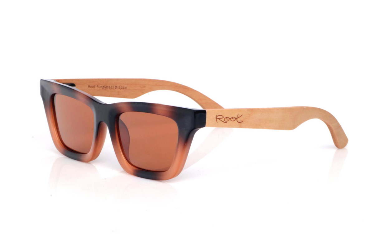 Wood eyewear of Maple MIRANDA. The MIRANDA wooden sunglasses combine clean, straight lines with a subtle cat-eye silhouette for a feminine, modern look. The frame features a tortoiseshell-style gradient in black and amber tones, adding depth and flattering contrast, while the warm-toned lenses complete the design with a soft, elegant touch.

Maple wood temples balance the look with a natural, lightweight finish, making them comfortable and easy to wear every day.

Dimensions: 140x43 mm
Calibre: 48
 for Wholesale & Retail | Root Sunglasses® 