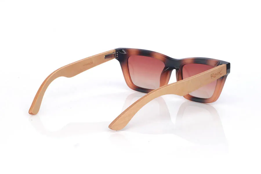 Wood eyewear of Maple MIRANDA. The MIRANDA wooden sunglasses combine clean, straight lines with a subtle cat-eye silhouette for a feminine, modern look. The frame features a tortoiseshell-style gradient in black and amber tones, adding depth and flattering contrast, while the warm-toned lenses complete the design with a soft, elegant touch.

Maple wood temples balance the look with a natural, lightweight finish, making them comfortable and easy to wear every day.

Dimensions: 140x43 mm
Calibre: 48
 for Wholesale & Retail | Root Sunglasses® 