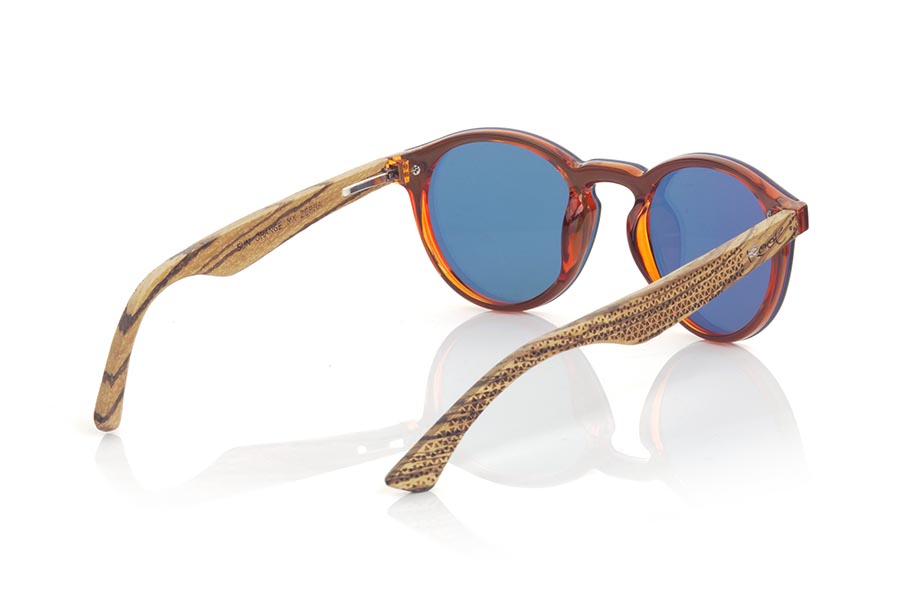 Wood eyewear of  SUN ORANGE. SUN ORANGE sunglasses are made with transparent orange synthetic material front and sideburns in zebra wood engraved with an ethnic pattern, it's a female model rounded very current trend <b>PC not POLARIZED</b>flat lenses cover around the front. Front size: 136X49mm for Wholesale & Retail | Root Sunglasses® 