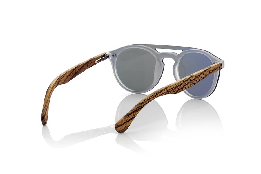 Wood eyewear of Zebrano SAMBA PURPLE. The SAMBA PURPLE sunglasses are made with the frontal of translucent synthetic material and the sideburns in zebra wood engraved with an ethnic pattern, this is a very rounded female model of current trend the flat lenses <b> non-polarized PC </b> Cover the whole frontal.. Frontal measurement: 137X49mm for Wholesale & Retail | Root Sunglasses® 