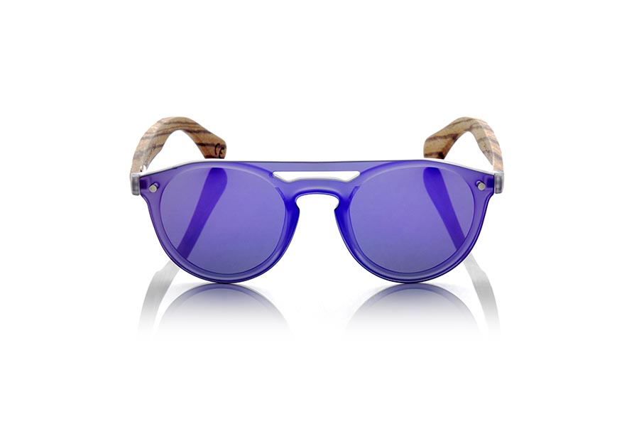 Wood eyewear of Zebrano SAMBA PURPLE. The SAMBA PURPLE sunglasses are made with the frontal of translucent synthetic material and the sideburns in zebra wood engraved with an ethnic pattern, this is a very rounded female model of current trend the flat lenses <b> non-polarized PC </b> Cover the whole frontal.. Frontal measurement: 137X49mm for Wholesale & Retail | Root Sunglasses® 