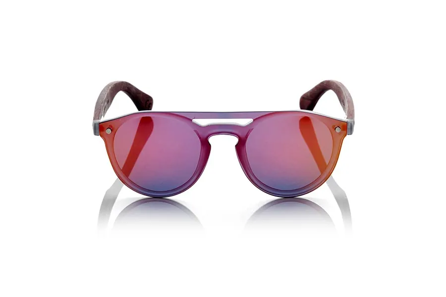 Wood eyewear of ROSEWOOD SAMBA RED. The SAMBA RED sunglasses are made with the frontal of translucent synthetic material and the sideburns in ROSEWOOD wood engraved with an ethnic pattern, this is a very rounded female model of current trend the flat lenses <b> non-polarized PC </b> Cover the whole frontal.. Frontal measurement: 137X49mm for Wholesale & Retail | Root Sunglasses® 