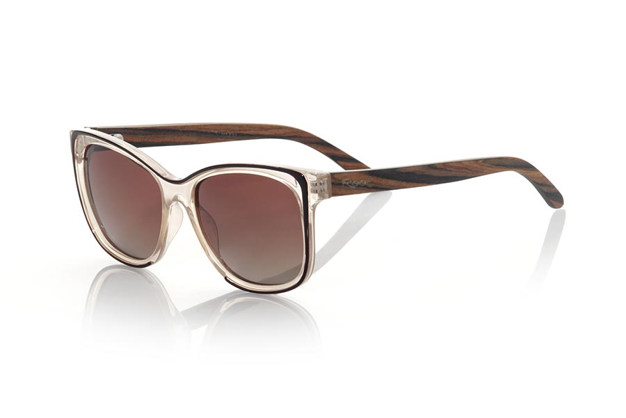 Wood eyewear of Rosewood PALOMA. The PALOMA sunglasses are made with the front in PC material transparent pink and black and the legs in natural rosewood. Very feminine model of suggestive shapes inspired by the beaches of CAPE DE PUNTA PALOMA, the PALOMA sunglasses have been combined as standard with several lenses. Front measurement: 143x53mm for Wholesale & Retail | Root Sunglasses® 