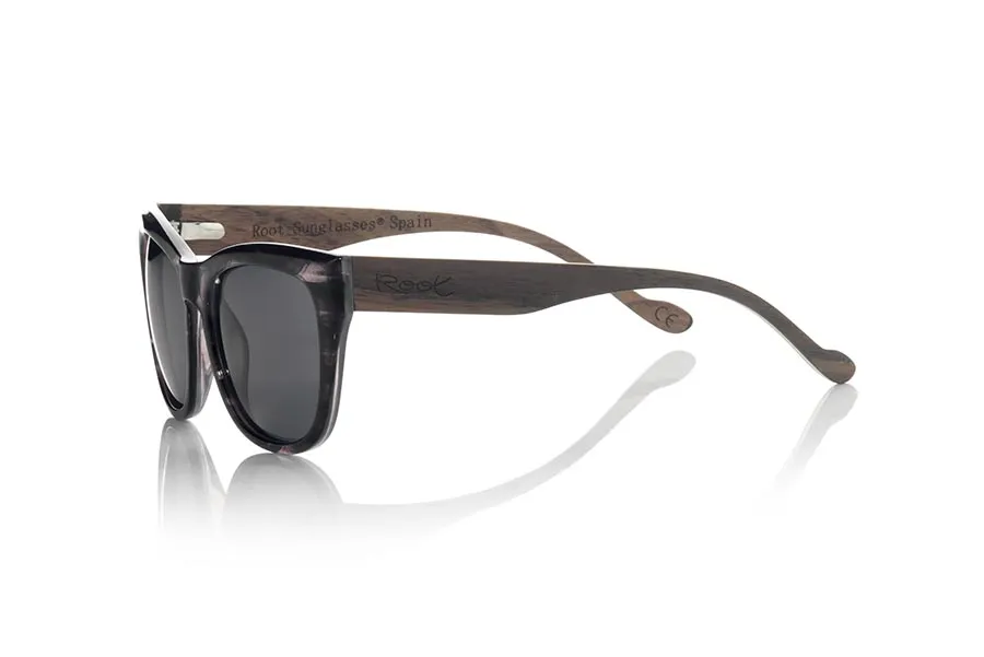 Wood eyewear of Walnut ESPARTEL. The ESPARTEL sunglasses are made with the front in marbel black PC material and NOGAL Natural wood legs. Very feminine model of suggestive shapes, the ESPARTEL sunglasses have been combined as standard with several lenses. Front measurement: 145x52mm for Wholesale & Retail | Root Sunglasses® 