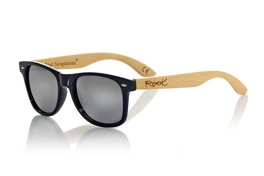 Wood eyewear of Bamboo CANDY BLACK. The Candy Black sunglasses are made with transparent sinthetic front in black gloss color and sideburns in natural bamboo combined with four lens colors that will adapt perfectly to your taste and your modern style. Front Measure: 148x50mm for Wholesale & Retail | Root Sunglasses® 