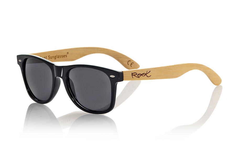 Wood eyewear of Bamboo CANDY BLACK. The Candy Black sunglasses are made with transparent sinthetic front in black gloss color and sideburns in natural bamboo combined with four lens colors that will adapt perfectly to your taste and your modern style. Front Measure: 148x50mm for Wholesale & Retail | Root Sunglasses® 