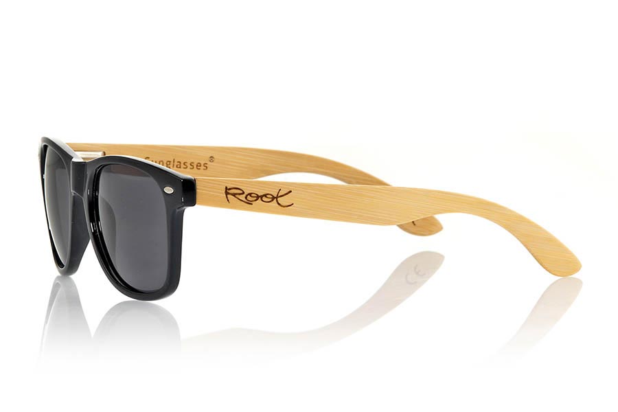 Wood eyewear of Bamboo CANDY BLACK. The Candy Black sunglasses are made with transparent sinthetic front in black gloss color and sideburns in natural bamboo combined with four lens colors that will adapt perfectly to your taste and your modern style. Front Measure: 148x50mm for Wholesale & Retail | Root Sunglasses® 