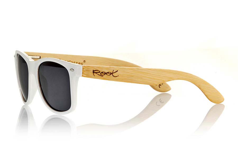 Wood eyewear of Bamboo CANDY WHITE. The Candy White sunglasses are made with transparent sinthetic front in white gloss color and sideburns in natural bamboo combined with four lens colors that will adapt perfectly to your taste and your modern style. Front Measure: 148x50mm for Wholesale & Retail | Root Sunglasses® 