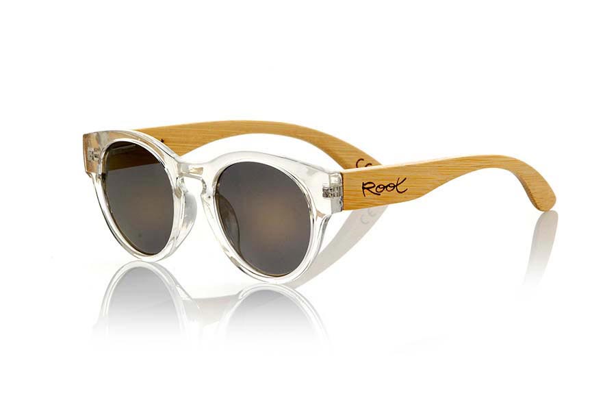 Wood eyewear of Bamboo GUM TR. Gum TR sunglasses are made with transparent sinthetic front and sideburns in natural bamboo combined with four lens colors that will adapt perfectly to your taste and your modern style. It is a rounded frame unisex standard size easy to carry. Front Measure: 148x50mm for Wholesale & Retail | Root Sunglasses® 