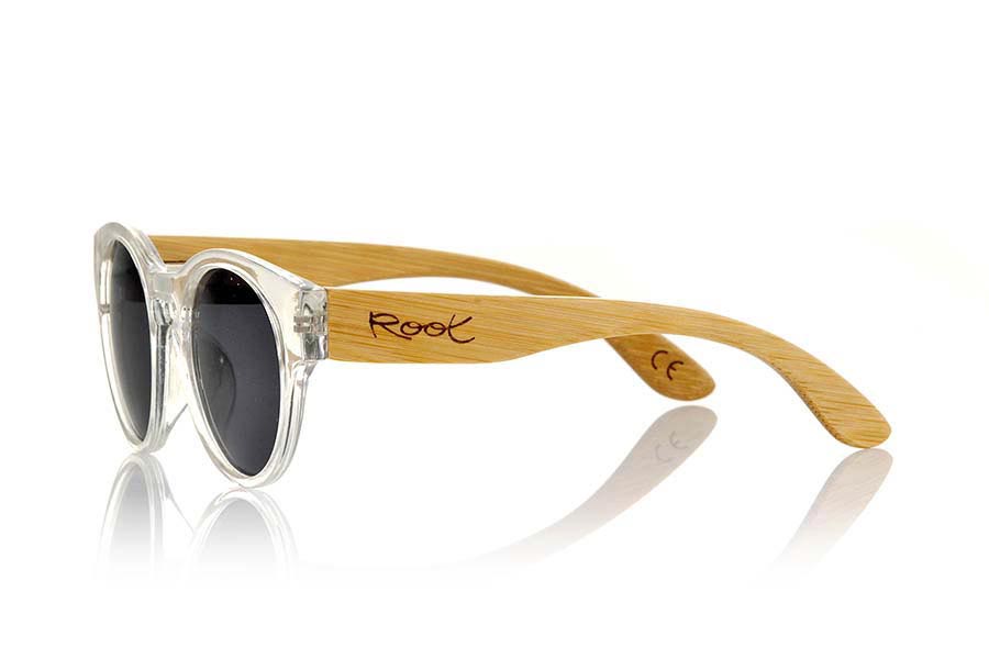 Wood eyewear of Bamboo GUM TR. Gum TR sunglasses are made with transparent sinthetic front and sideburns in natural bamboo combined with four lens colors that will adapt perfectly to your taste and your modern style. It is a rounded frame unisex standard size easy to carry. Front Measure: 148x50mm for Wholesale & Retail | Root Sunglasses® 