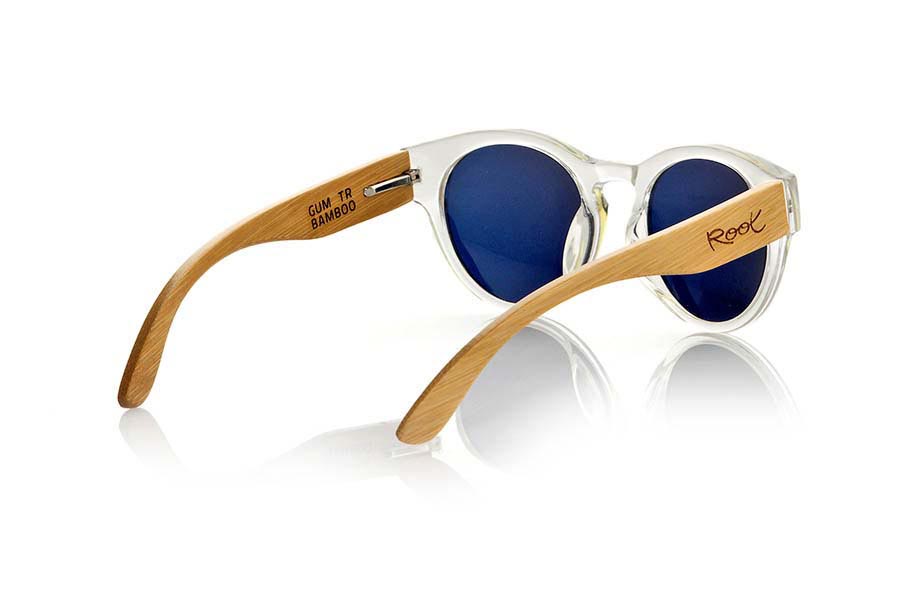 Wood eyewear of Bamboo GUM TR. Gum TR sunglasses are made with transparent sinthetic front and sideburns in natural bamboo combined with four lens colors that will adapt perfectly to your taste and your modern style. It is a rounded frame unisex standard size easy to carry. Front Measure: 148x50mm for Wholesale & Retail | Root Sunglasses® 