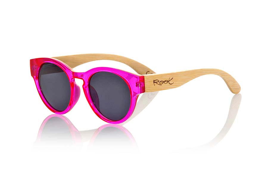 Wood eyewear of Bamboo GUM PINK. Gum Pink sunglasses are made with transparent sinthetic pink color front and sideburns in natural bamboo combined with four lens colors that will adapt perfectly to your taste and your modern style. It is a rounded frame unisex standard size easy to carry. Front Measure: 148x50mm for Wholesale & Retail | Root Sunglasses® 