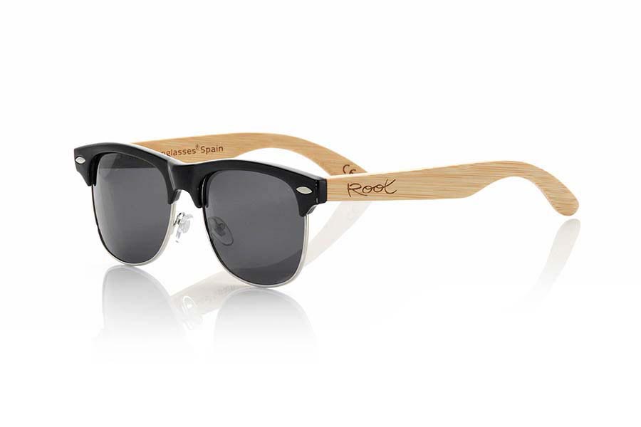 Wood eyewear of Bamboo PRAGUE. RAGUE sunglasses are made with synthetic front in black gloss and sideburns natural bamboo wood. S and is a classic and very popular style mount the Clubmaster combined with the silver ring standard with lenses REVO Blue or Gray. You'll love this model optimized measurements made with materials of high quality and perfect finish. Front Measure: 145x50mm for Wholesale & Retail | Root Sunglasses® 