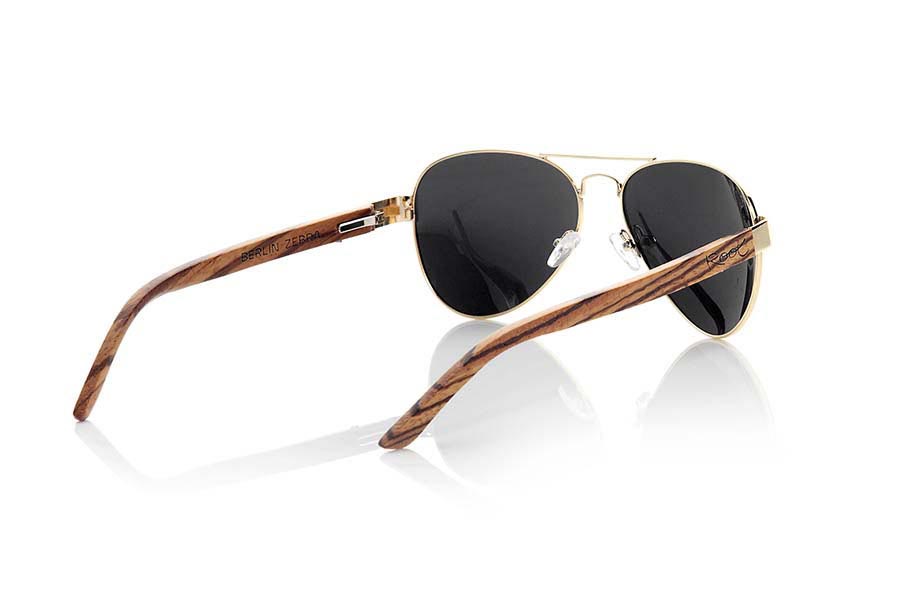 Wood eyewear of Zebrano BERLIN. BERLIN sunglasses are made from the metal frame and sideburns natural Zebrano wood. A classic Aviator style model series combined with yellow lenses REVO, REVO Blue or Gray REVO. You'll love the combination of zebra wood. Front Measure: 150x50mm for Wholesale & Retail | Root Sunglasses® 